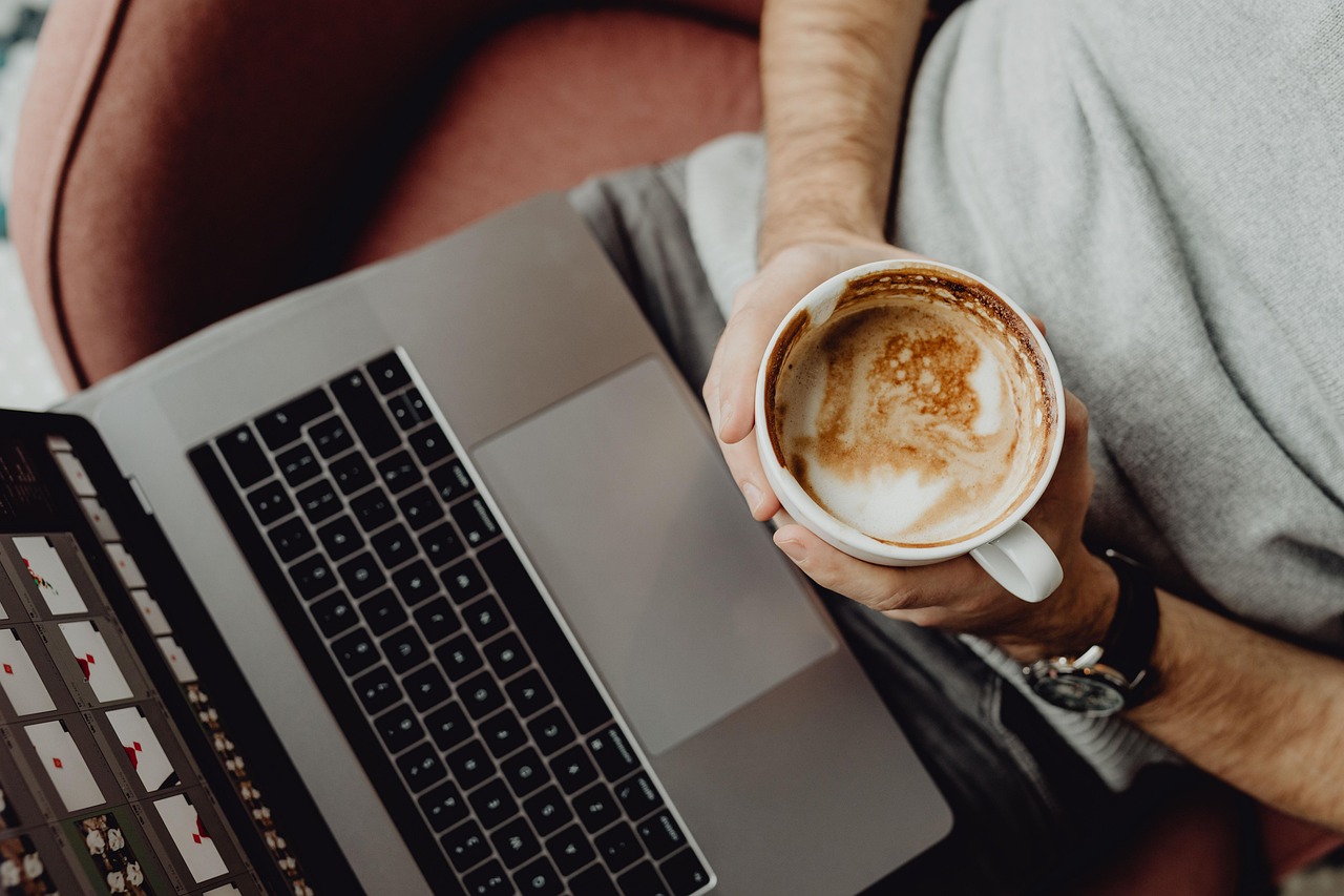 Coffee, cup, computer — Top two reasons why people prefer to watch online movies